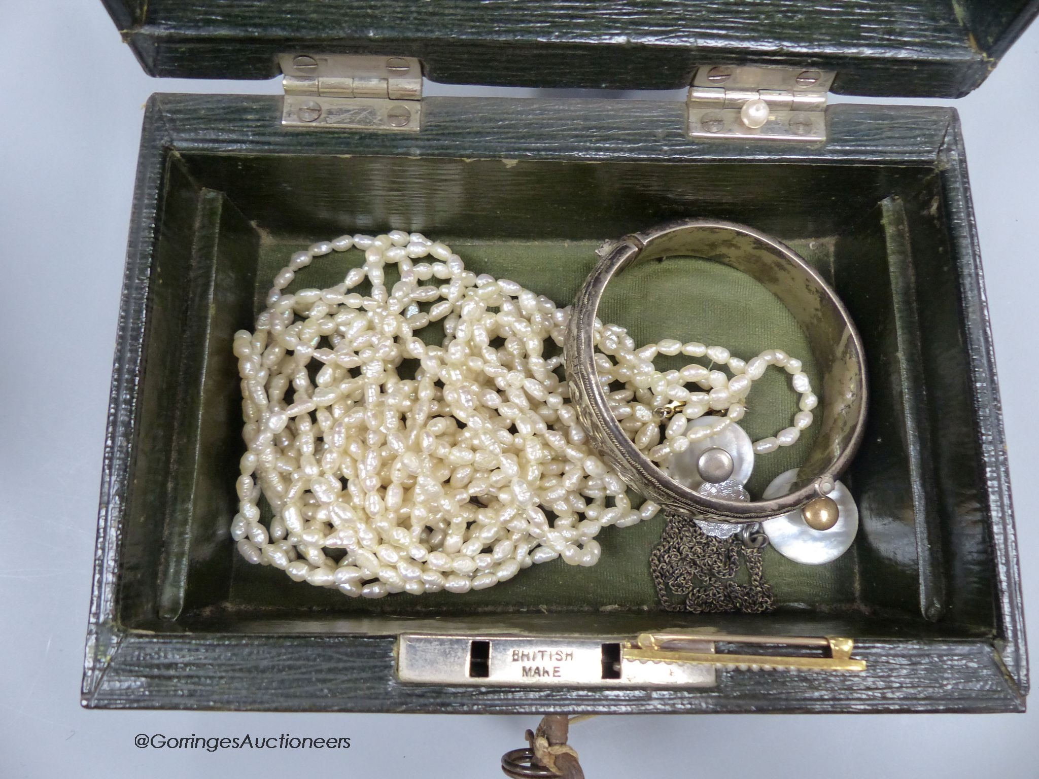 A small green leather jewellery box of assorted minor jewellery